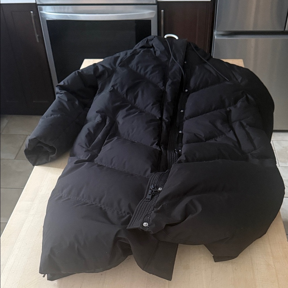 Women Long Black Puffer Jacket with hood.